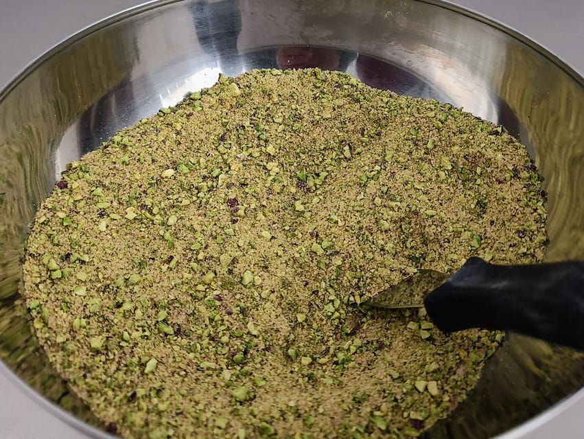 Chocolatier for a day: raw bean to bar chocolate in Modica - Grinding cacao with traditional stone equipment