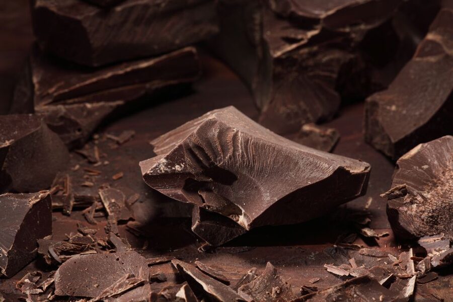 Broken slabs of dark chocolate on a tasting bench